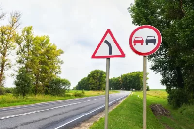 Road signs 'overtaking is prohibited' and a 'dangerous turn'