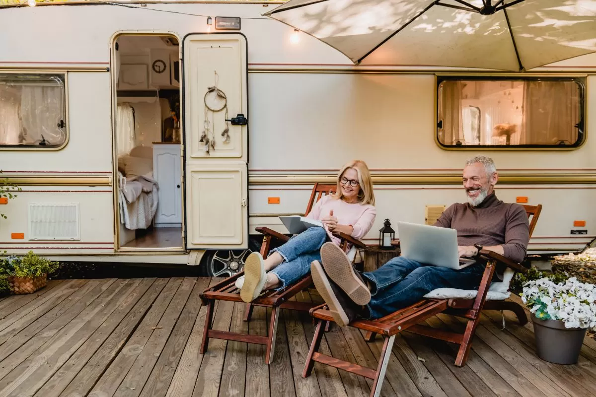 Happy aged couple near the camper van