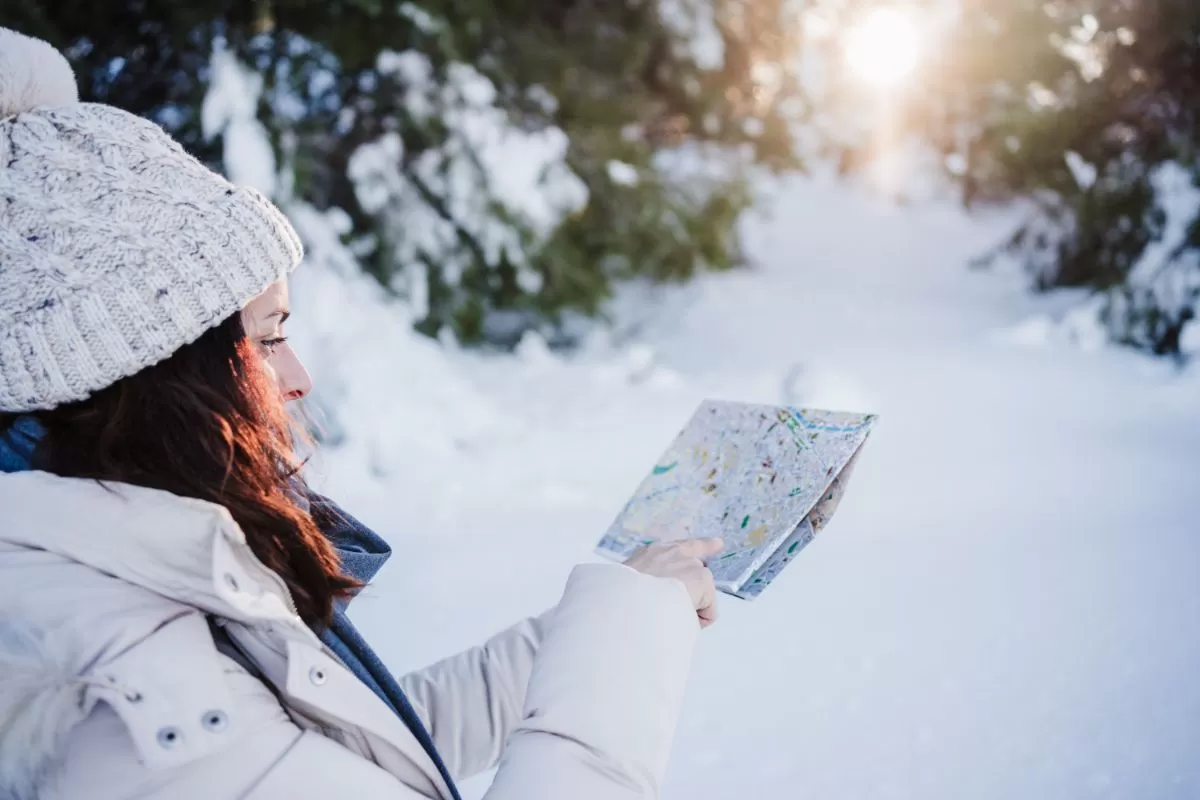 Traveller looking at the map at winter